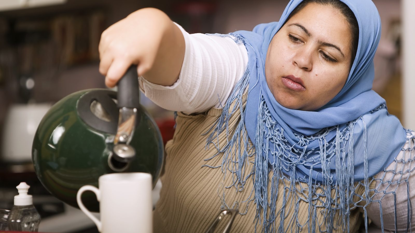 Muslim woman pouring tea