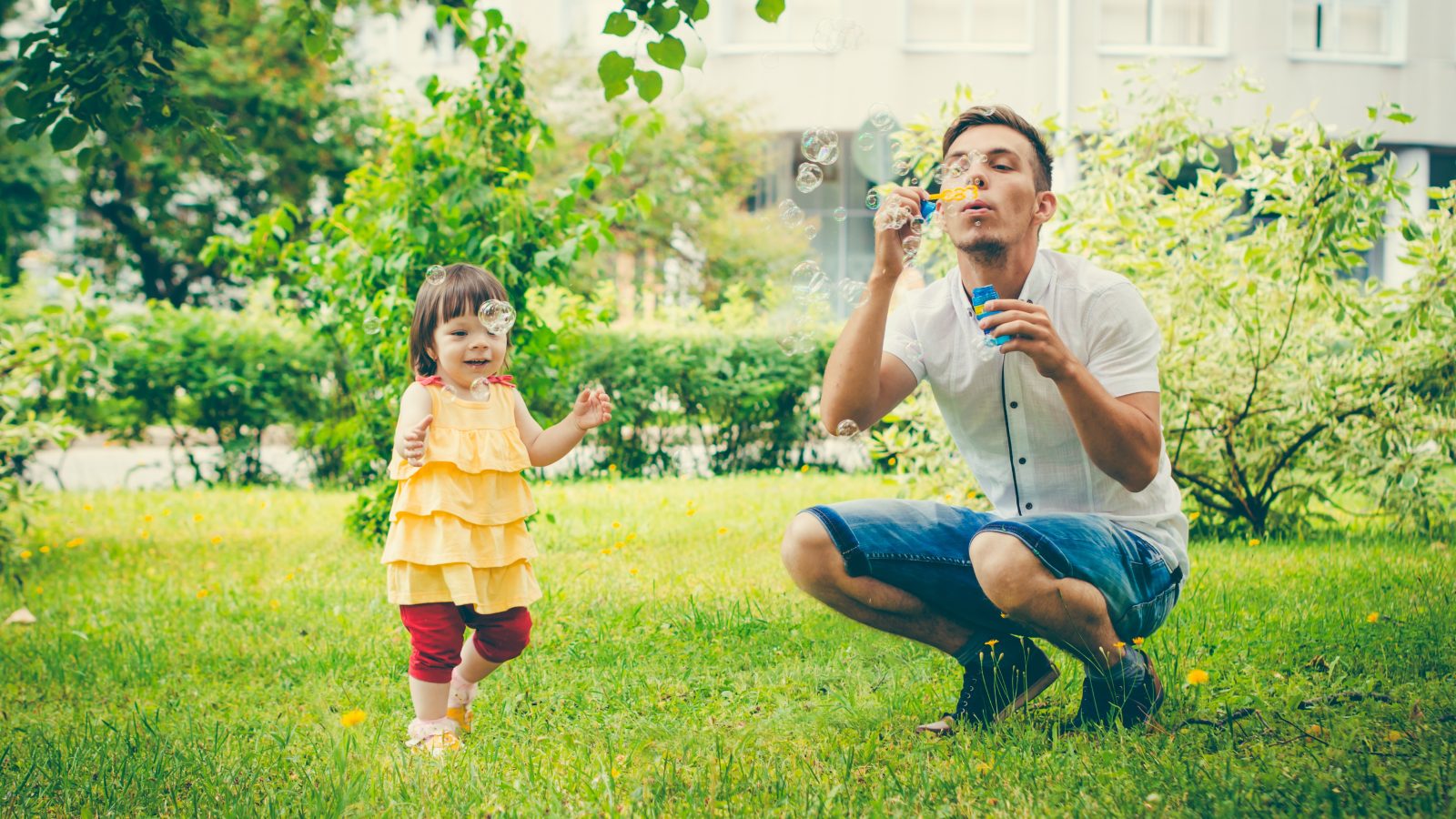 Dad and his daughter are making bubbles