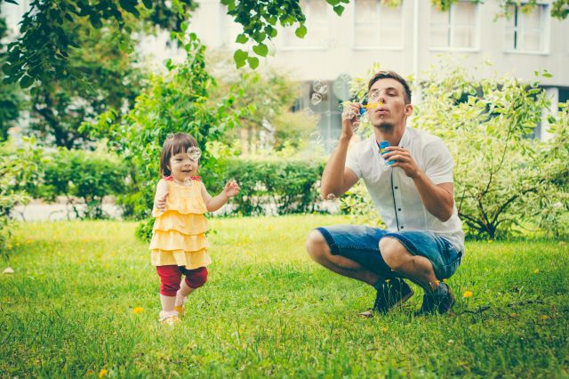Dad and his daughter are making bubbles
