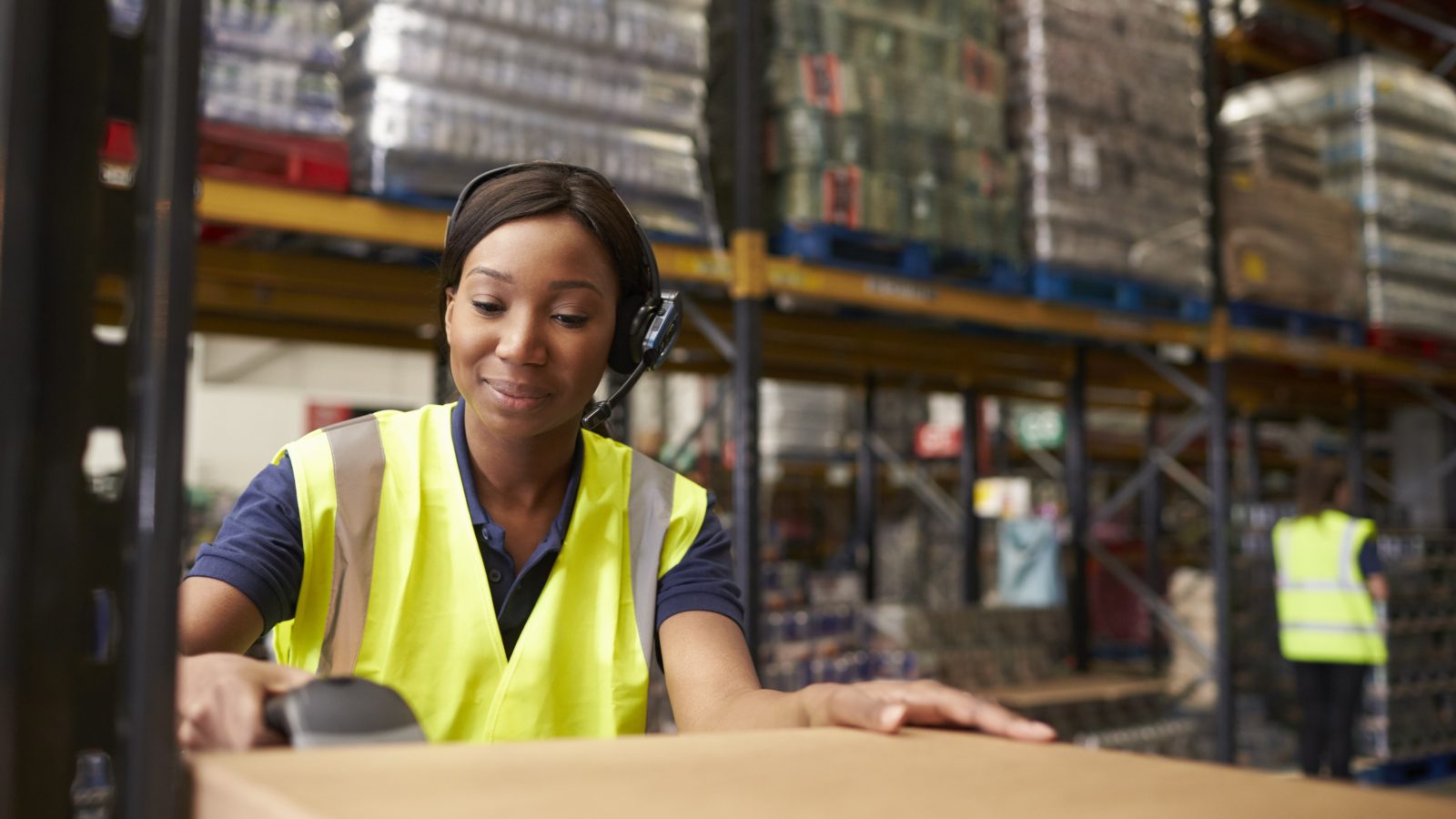 Woman using a barcode reader in a distribution warehouse