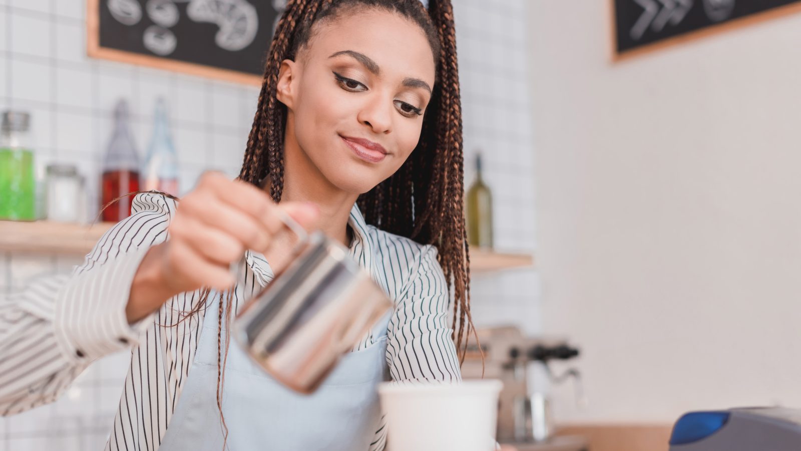 Barista häller upp kaffe på café