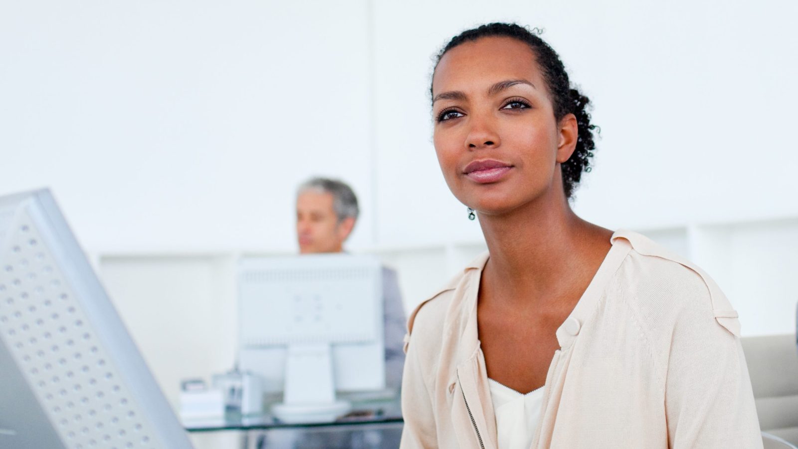 Afro-american businesswoman working at a computer in the office