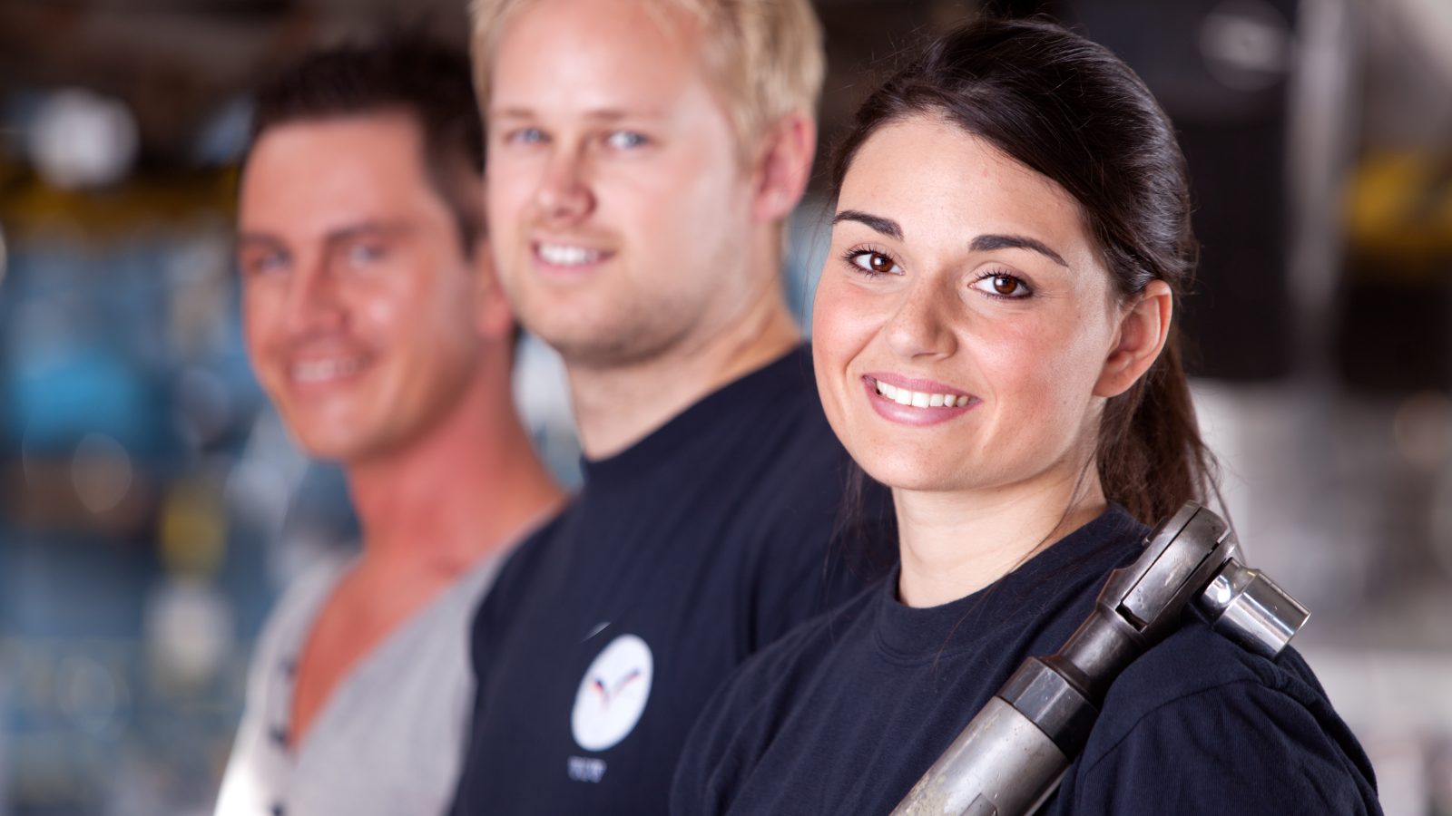 Portrait of a team of mechanics with a woman in the forground