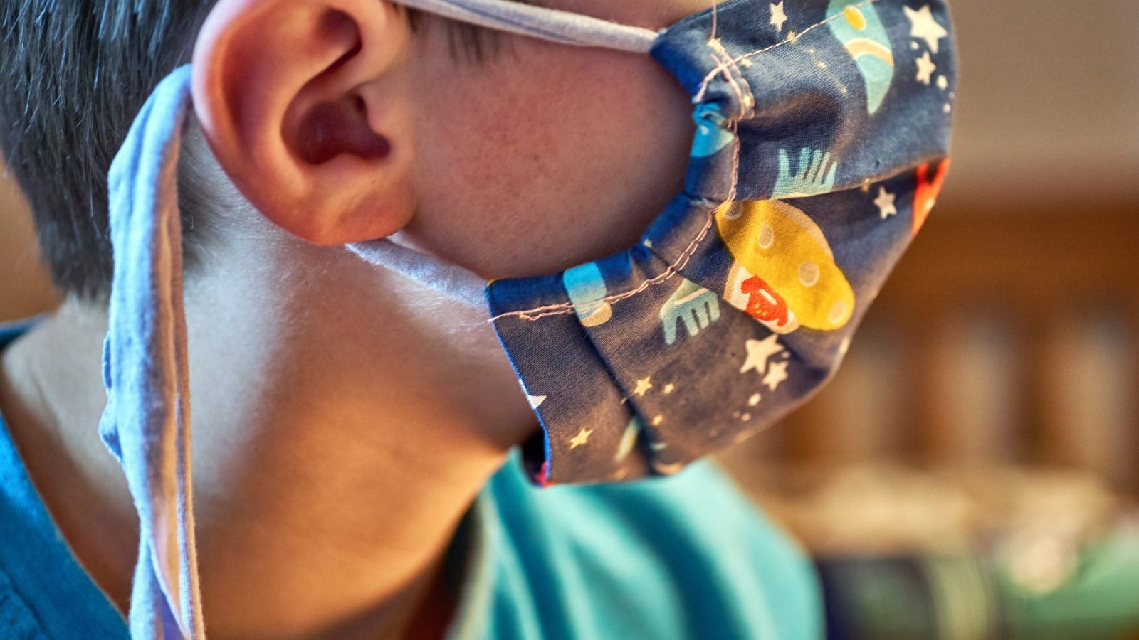 Child with handmade sewn mask to protect against corona viruses.