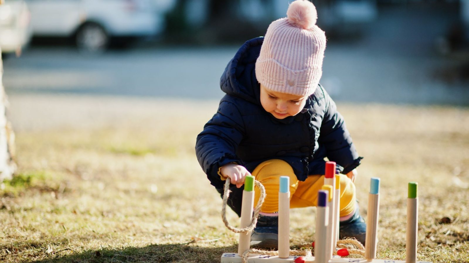 girl playing, throwing ring toss outdoor